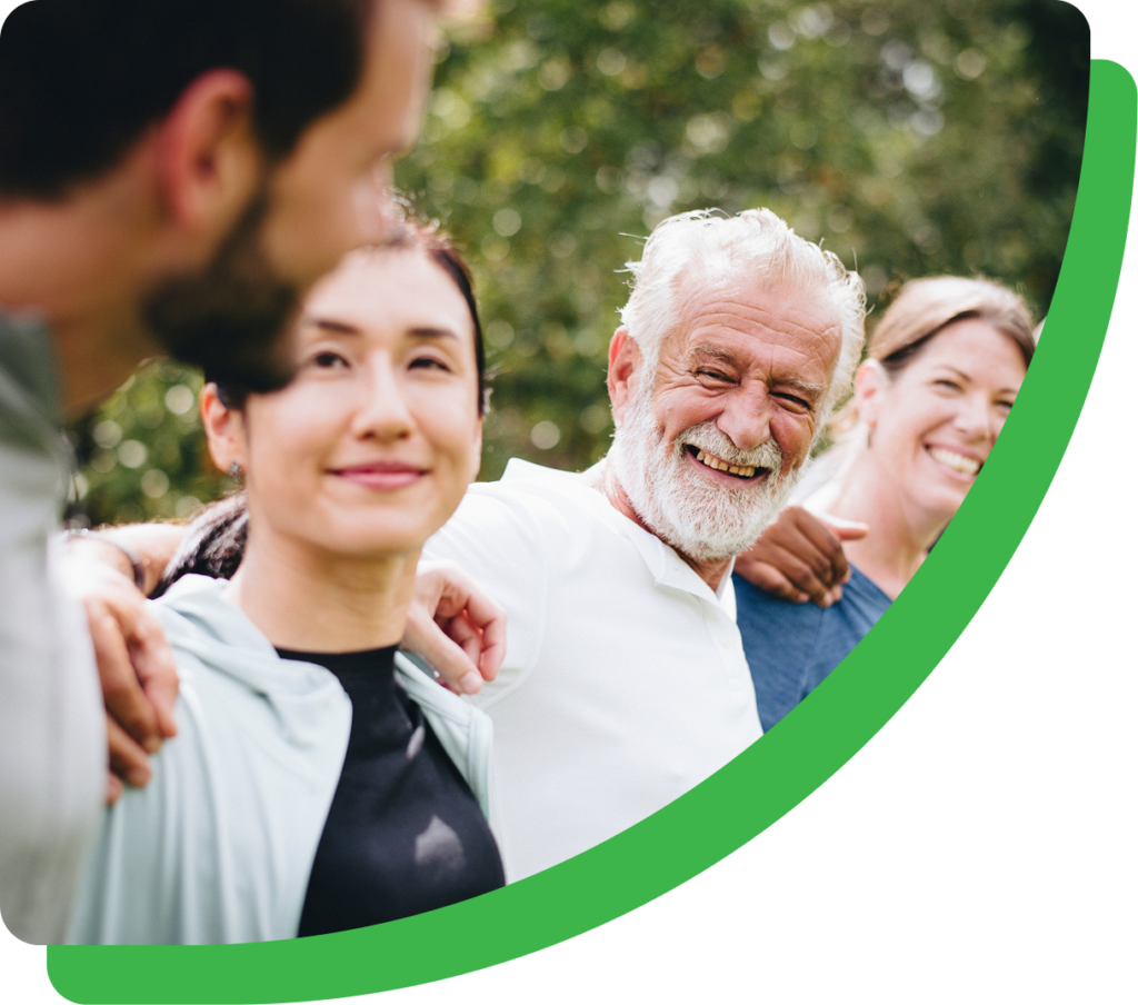 People smiling and holding each other outside